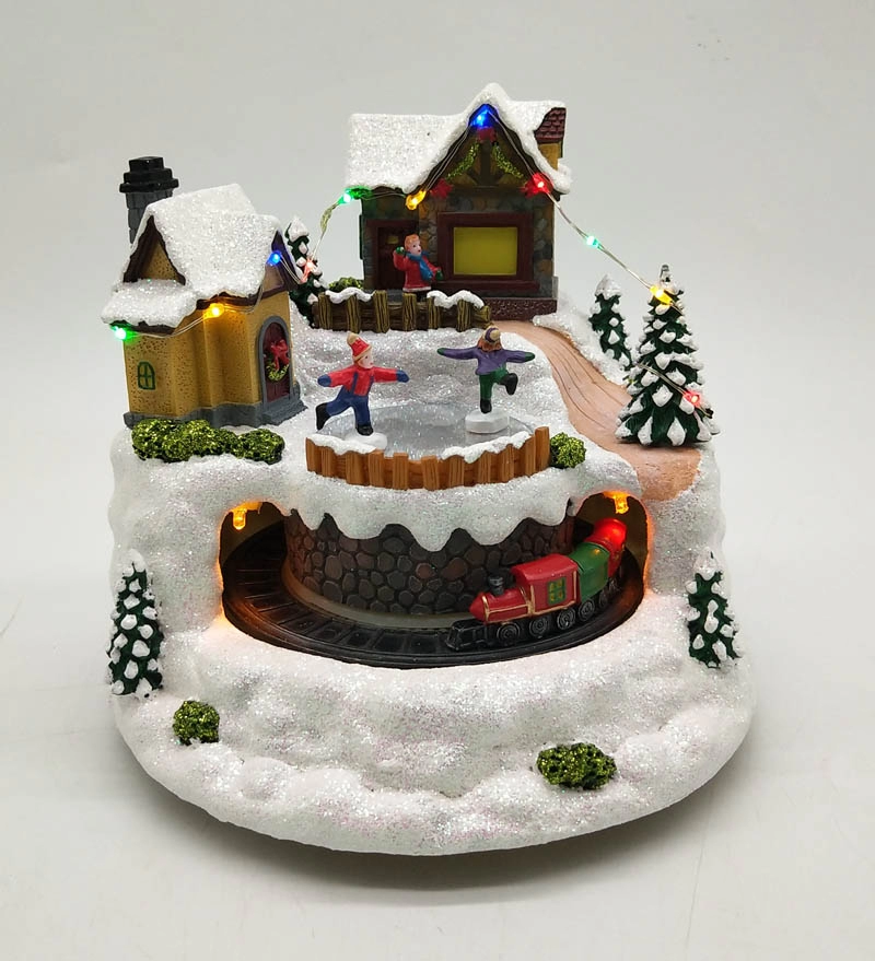 Осветите анимированную рождественскую деревню с движущимися поездами и катающимися на коньках детьми
